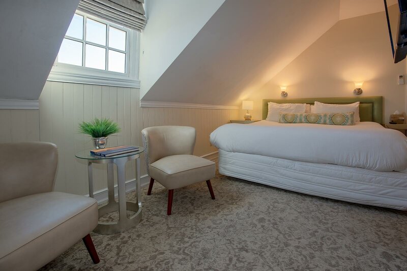 Room Six with view of chairs and bed